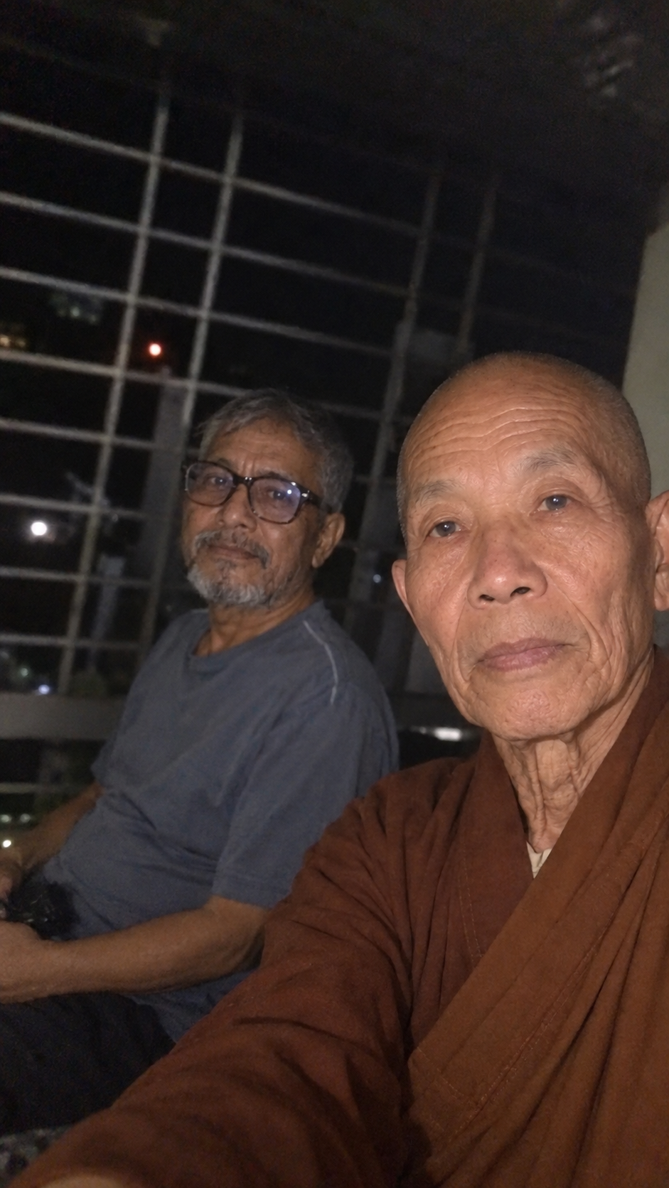 Two older men standing together on a beach